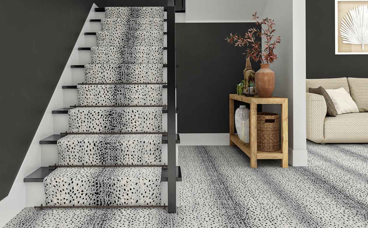 animal print carpet on staircase in modern foyer with dark gray walls